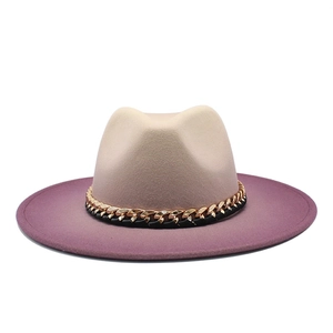 Detail of felt fedora with beige crown, purple brim, and decorative golden chain strap