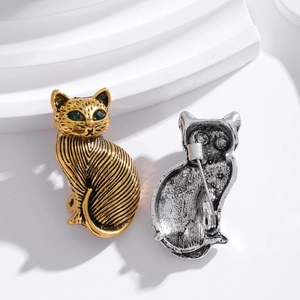 Vintage cat brooch set in gold and silver finish showing front and back metal details