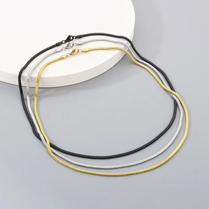 Detailed view of 18K gold plated snake bone chains in gold, silver, and black colors