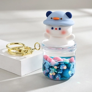 Creative liquid quicksand keychain with cute white bear in blue hat and colorful beads