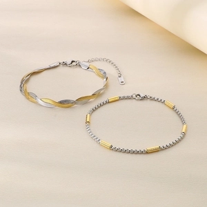 Detail of two-tone stainless steel snake and square box chains with gold accents