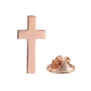 Detail of classic rose gold cross brooch with butterfly clasp on white background