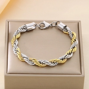 Detailed close-up of gold and silver rope chain bracelet with secure lobster clasp