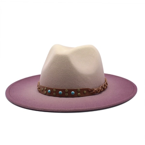 Detailed view of wide brim felt fedora with beige to purple gradient and studded band