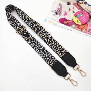 Detail of adjustable leopard print bag strap with gold metal swivel hooks and leather ends