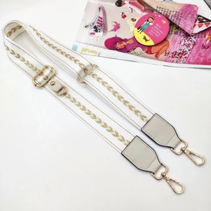 Adjustable woven white strap with gold chevron pattern and metal lobster clasps