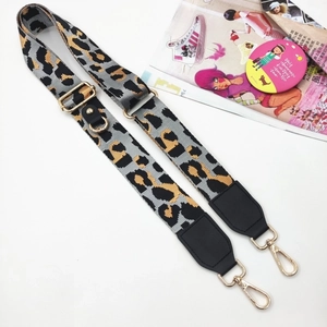 Detail of adjustable leopard print wide shoulder strap with gold metal hooks and buckle