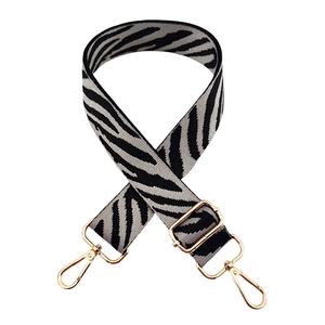 Close-up of adjustable zebra print shoulder strap with premium gold metal hardware