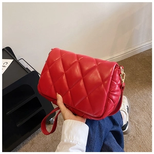 Quilted red cotton-padded crossbody bag with gold hardware for winter fashion styles