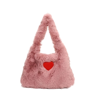 Pink plush crossbody bag with red heart pattern for women shown on white background