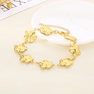 Close-up of golden stainless steel flower bracelet with lobster clasp and extension chain