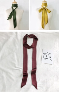 Detailed views of solid color satin skinny scarves in dark green, mustard yellow, and burgundy
