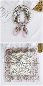 Detail of baroque pattern silk square scarf with golden scrollwork and pink borders