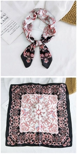 Detail of red and black baroque pattern square silk scarf with elegant drape and texture