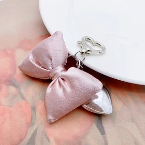 Elegant champagne pink satin bow keychain with silver heart pendant for handbags
