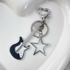 Y2K guitar and star metal keychain with heart clip in a white aesthetic tray