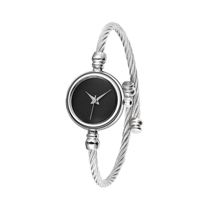 Detail of silver twisted cable bangle watch featuring a minimalist black round dial