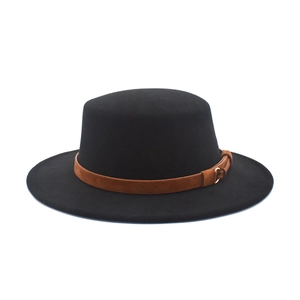 Detail of black wool felt hat featuring a brown suede band and golden round buckle accent