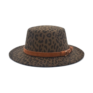 Detail of leopard print flat top wool hat with tan suede band and gold metal buckle