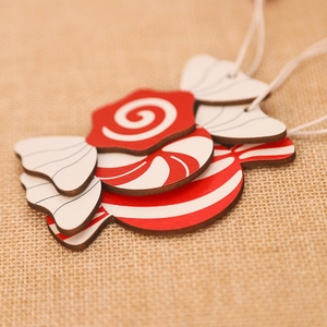 Christmas tree wooden candy ornaments in red and white stripes with hanging strings