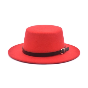 Detail of red wool felt boater hat featuring a black leather band and gold buckle