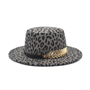 Detail of leopard print felt hat featuring a black band with a golden feather ornament