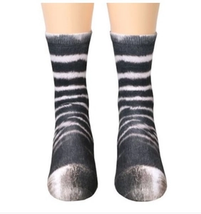 Detailed view of 3D animal paw print socks with zebra-like fur pattern on a model