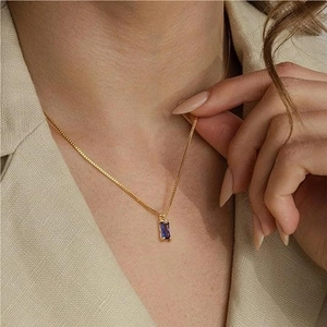 Elegant 18k gold plated necklace featuring a rectangular blue emerald-cut gemstone pendant