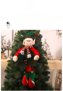 Close-up of a festive Christmas elf plush toy hanging on a decorated tree branch