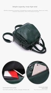 Detail view of multi-pocket storage capacity and textured dark green leather backpack