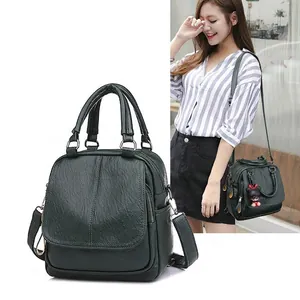 Versatile forest green lychee textured women backpack and handbag shown with model