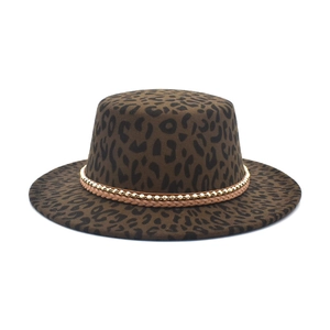 Detail of leopard print fedora with golden bead chain and leather decorative bands