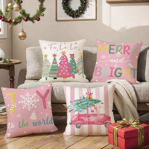 Set of 4 pink Christmas tree polyester pillow covers on a cozy festive living room sofa