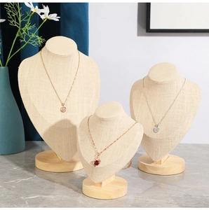 Linen necklace bust display stands with wooden bases for jewelry storage in three heights