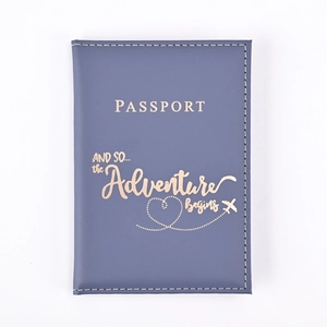 Detail of navy blue PU leather passport holder with golden adventure quote and heart plane