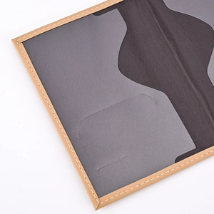 Detailed close-up of dark grey PU leather car seat organizer with beige stitching accents