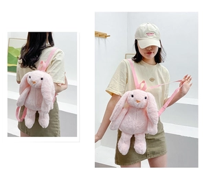 Detailed view of soft pink plush rabbit backpack with long ears and adjustable straps