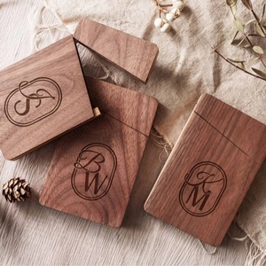 Custom engraved black walnut business card cases with personalized initials on wood
