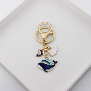 Cute golden metal keychain with blue whale and white cloud enamel charms for bags