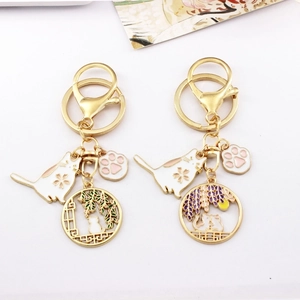Japanese style gold alloy cat and cherry blossom keychain pendants with enamel details