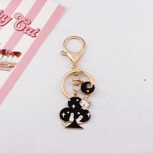 Cute black enamel cat keychain with star patterns and a gold-tone crescent moon pendant