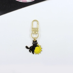 Gothic black cat hugging yellow sun enamel keychain with golden metal clasp and swivel ring