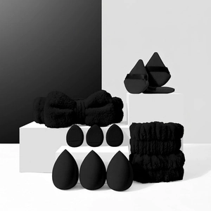 Macro shot of black makeup sponge set with plush bow headband and wristbands