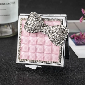 Square silver folding makeup mirror with pink quilted design and rhinestone bow