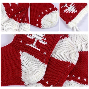 Detailed view of red and white knitted Christmas stockings with reindeer and tree patterns