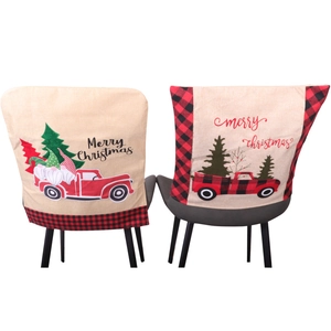 Linen Christmas chair covers featuring red truck and gnome designs for festive dining decor