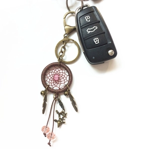 Handmade brown dreamcatcher keychain with bronze feathers and pink beads for bags or cars