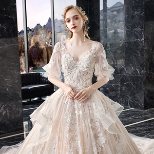 Elegant deep V-neck bridal gown with floral lace embroidery and tiered ruffle mesh skirt