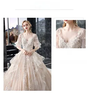 Detailed view of the champagne bridal gown featuring V-neck lace and floral embroidery