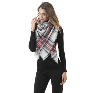 Detail of red and grey plaid cashmere-like scarf with tassels on a female model